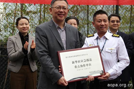 新华社四川分社社长房方（左）向四川西林凤腾通用航空有限公司董事长林孝波（右）授牌“新华社应急报道重点协作单位”。